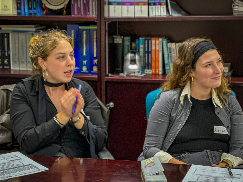 Two Impact Lab students engaged in discussion while answering Lucia’s question.